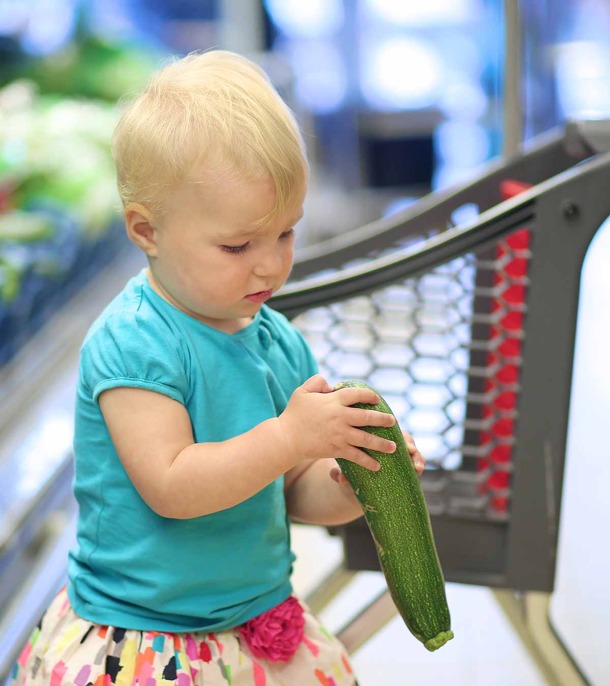 A Toddler Holding Zucchini