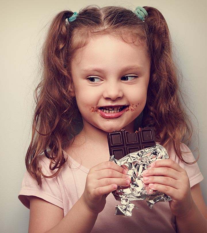 A small girl eating chocolates