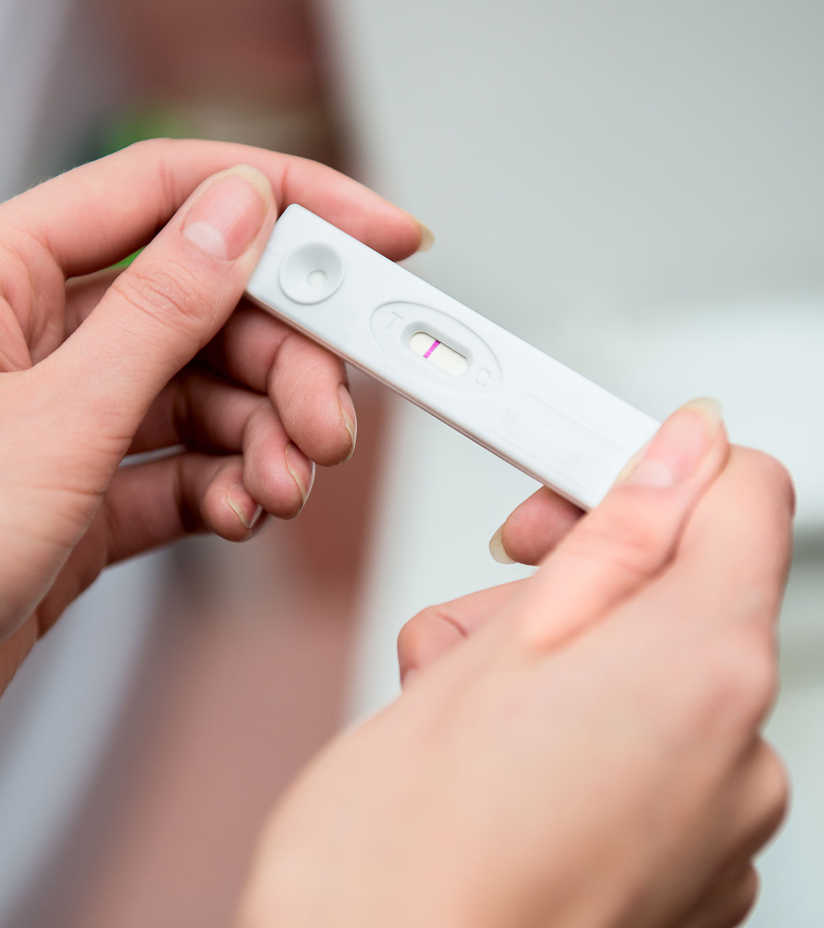 Women Checking Faint Line Pregnancy Test