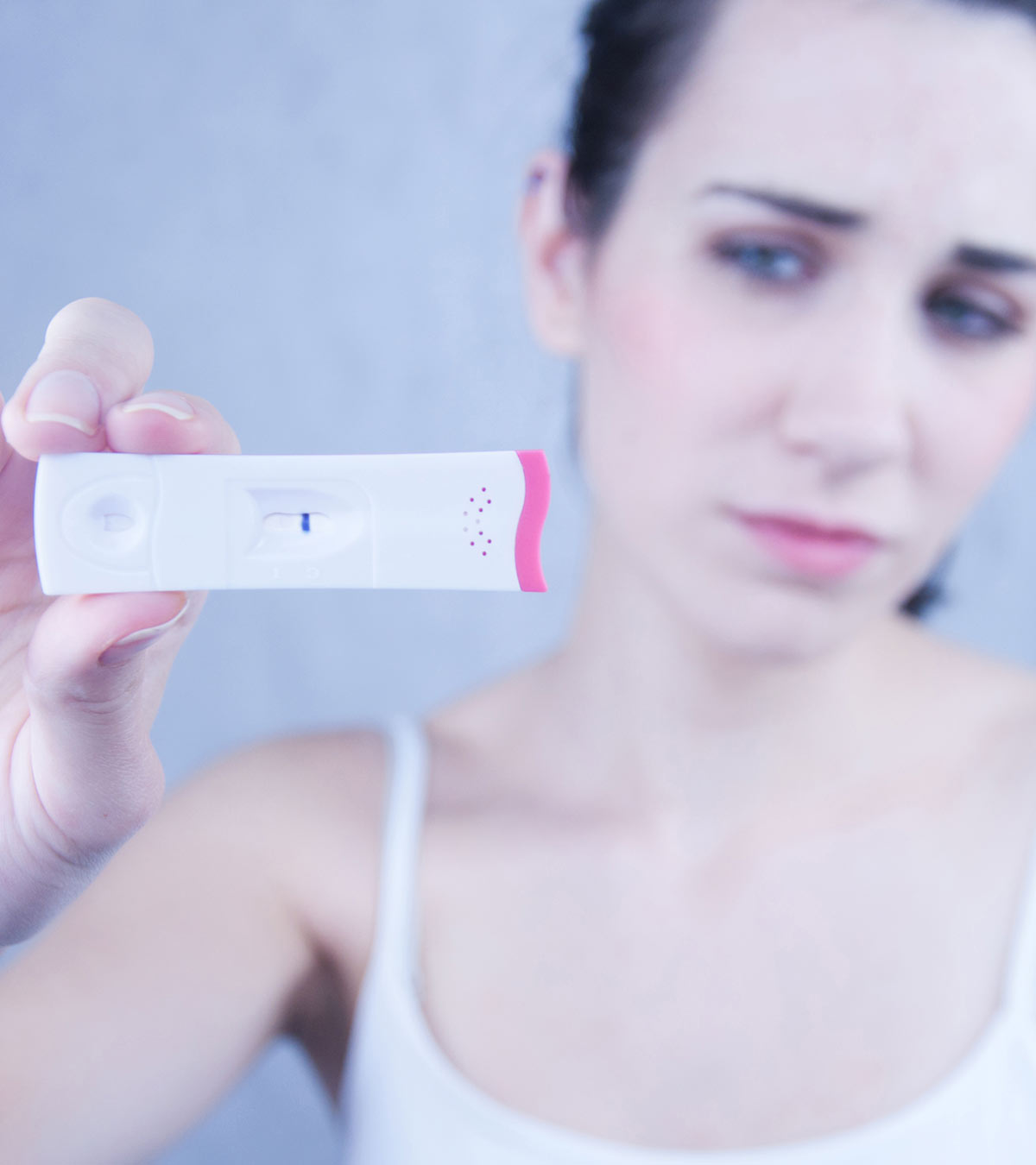 Women Checking False Positive Pregnancy Test At Home