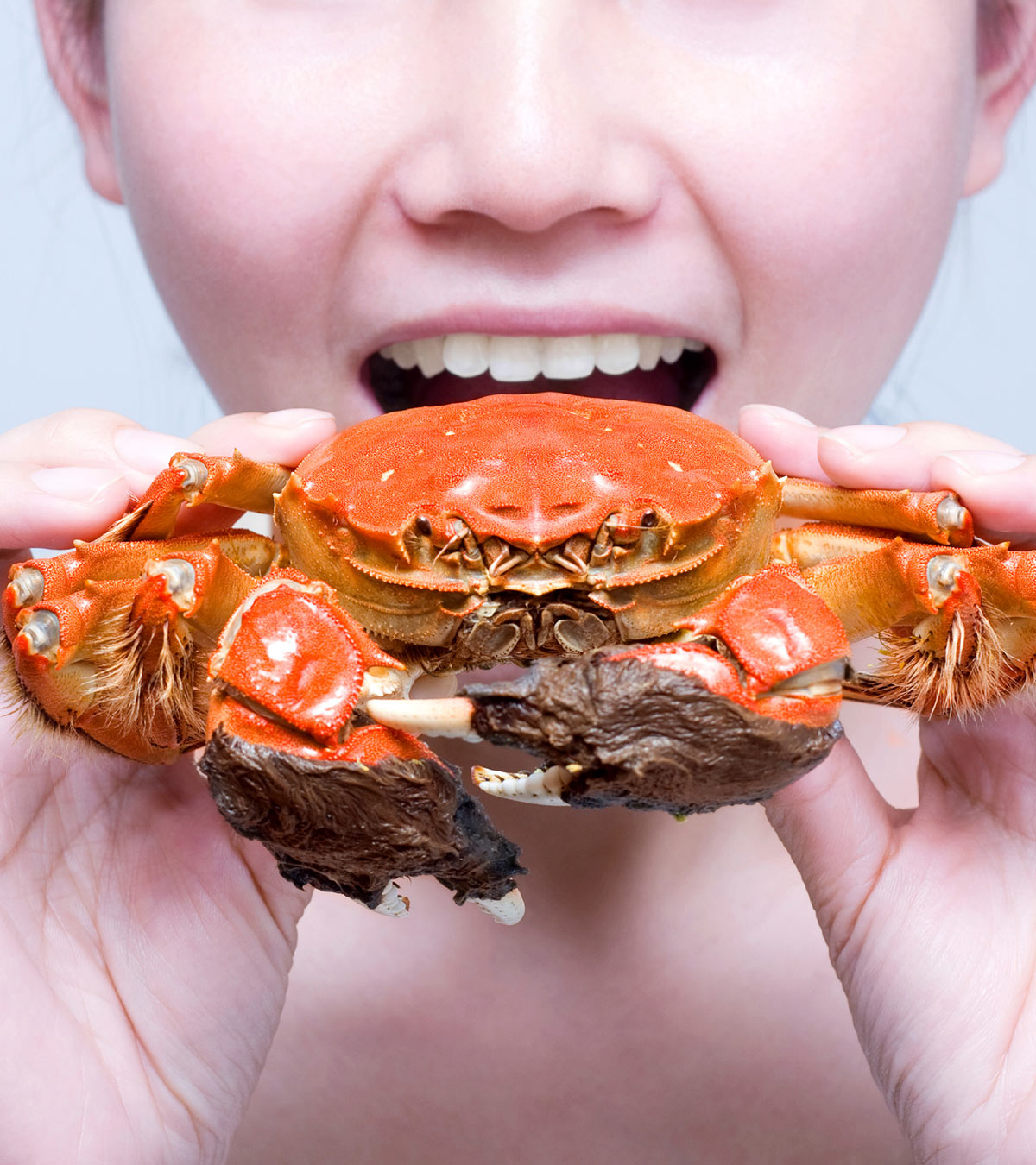 A girl holds a crab