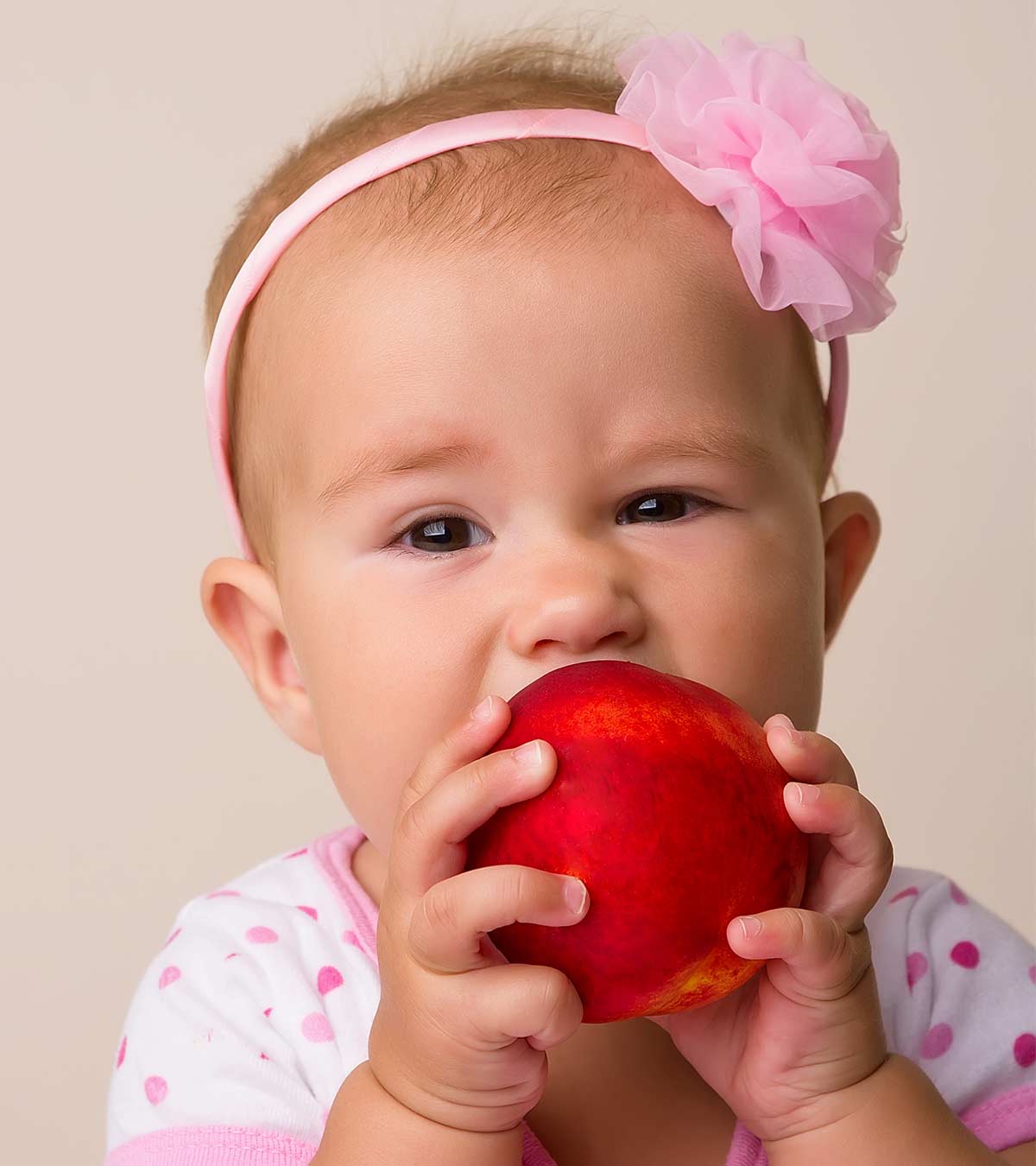 A Baby Eating Peach Fruit