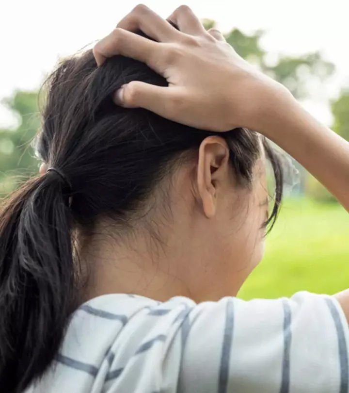 A child scratching her scalp